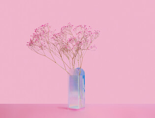 Purple dry flowers in vase on table