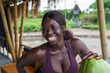 © Jovo Jovanovic/Stocksy - Woman holding a fresh coconut in a resort