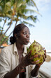 © Jovo Jovanovic/Stocksy - Woman drinking coconut water through a straw