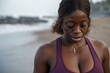 © Jovo Jovanovic/Stocksy - Woman at the beach looking down upper body closeup