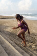 © Jovo Jovanovic/Stocksy - Woman running on the stairs at a sandy beach