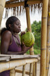 © Jovo Jovanovic/Stocksy - Woman drinking coconut water through a straw