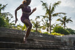 © Jovo Jovanovic/Stocksy - Woman climbing down a set of stairs covered with sand