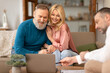 © Prostock-studio - Male Consulting Senior Couple Showing Laptop Selling Real Estate Indoor