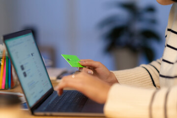 Woman paying with credit card on internet