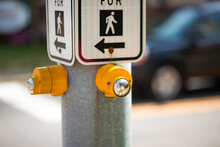 Crosswalk Sign Buttons With Car In Background