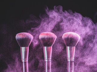 Wall Mural - Cosmetics brush and explosion colorful makeup powder background - beauty make-up product and mineral cosmetic concept