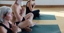 Meditative Group Yoga Class Practice Inside Modern Studio.
