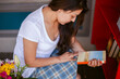 © ByLorena/Stocksy - Woman reading cover Books at storefront