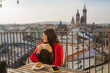 © Dima Sikorski/Stocksy - A happy tourist has breakfast on the terrace in the old European city