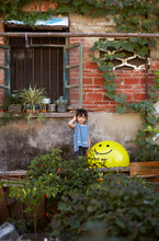 Asian Girl With Her Own Mood Balloons In Front Of The Old House