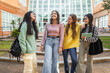 © Lupe Rodríguez/Stocksy - female student friends in front of the faculty at the university
