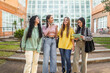 © Lupe Rodríguez/Stocksy - female student friends in front of the faculty at the university