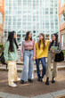 © Lupe Rodríguez/Stocksy - female student friends in front of the faculty at the university