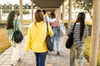 © Lupe Rodríguez/Stocksy - group of students walking through the university campus