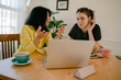© Léa Jones/Stocksy - woman explaining a business project to her younger co worker