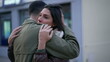 Couple embrace in empathy calming partner during difficult times. A MIddle Eastern male person hugging female friend. Empathic embrace. Two people hug outside in street