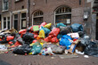 © Rene de Haan/Stocksy - pile of trash on street