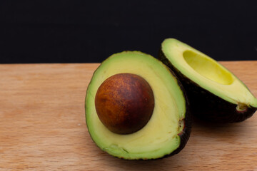 Avocado cut into two halves with pit