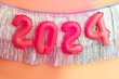 © Alison Winterroth/Stocksy - 2024 Balloons on tinsel banner