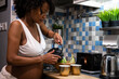 © Atolas/Stocksy - Pregnant woman preparing tea