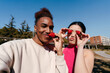 © Lucas Ottone/Stocksy - Funny selfie of multiracial couple eating strawberries