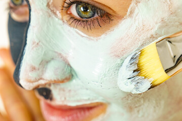 Wall Mural - Female applying green mud facial mask