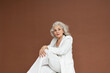 © Hernandez & Sorokina/Stocksy - Senior Fashion Model With Silver Hair Portrait