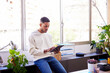 © ALTO IMAGES/Stocksy - Focused young black man browsing tablet