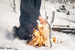 © Lior + Lone/Stocksy - Man in snow maintaining camp fire