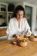 © Mihajlo Ckovric/Stocksy - Portrait of a woman prepare food in kitchen