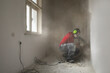 © Jelena Jojic Tomic/Stocksy - Construction worker working on the old interior wall