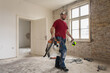 © Jelena Jojic Tomic/Stocksy - A construction worker in the apartment during a home renovation