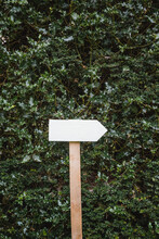 White Handmade Wooden Sign Pointing To The Right