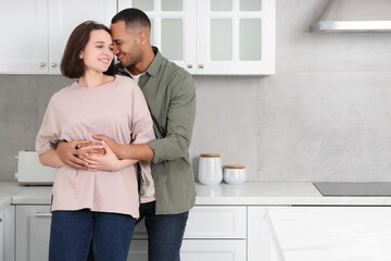 Wall Mural - Dating agency. Lovely couple embracing in kitchen, space for text