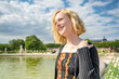 A beautiful forty something woman enjoys traveling in Paris, France, visiting the historic Tuileries Park.