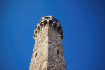 Clock Tower Standing Tall Against a Blue Sky. Generative AI