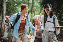 Woman Family Walking In The Forest To Watching A Bird In Nature, Using Binocular For Birding By Looking On A Tree, Adventure Travel Activity In Outdoor Trekking Lifestyle, Searching Wildlife In Jungle