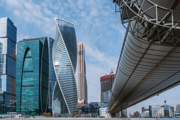 Wall Mural - Pedestrian Bridge Bagration on Moscow river with skyscrapers Moscow City on the background. Moscow. Russia