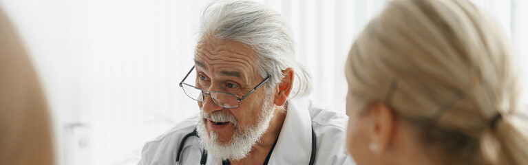 Sticker - Group of doctors sitting at meeting table in conference room during medical seminar