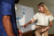 © DragonImages - Businesswoman explaining data in report to colleague at meeting