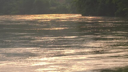 Wall Mural - river water flowing at sunset
