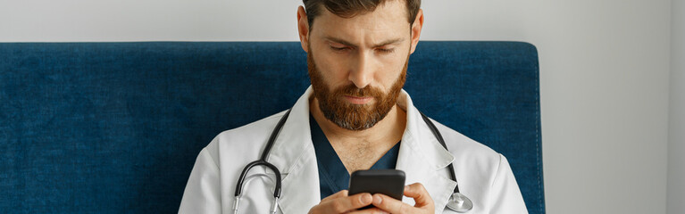 Wall Mural - Doctor therapist use phone during break in medicine office