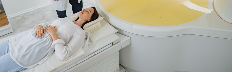 Wall Mural - Radiologist controls MRI or CT or PET Scan with female patient undergoing procedure