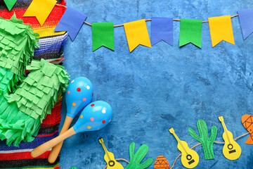 Wall Mural - Frame made of Mexican maracas, pinata, garland and flags on grunge background