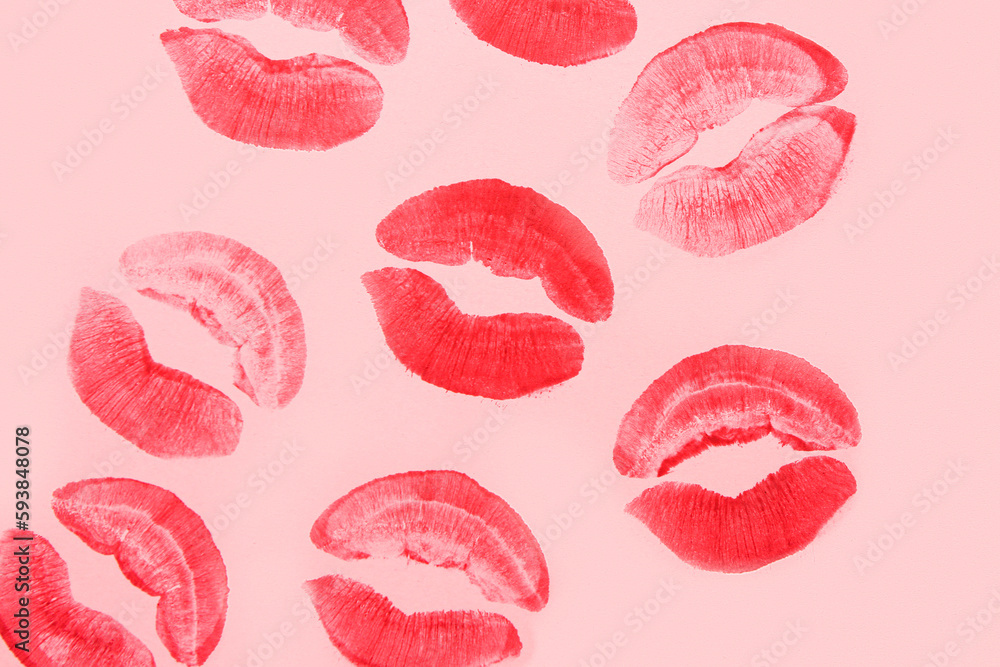 Red lipstick kiss marks on pink background