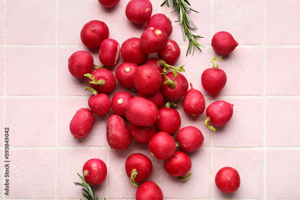 Heap of fresh radish on pink tile background