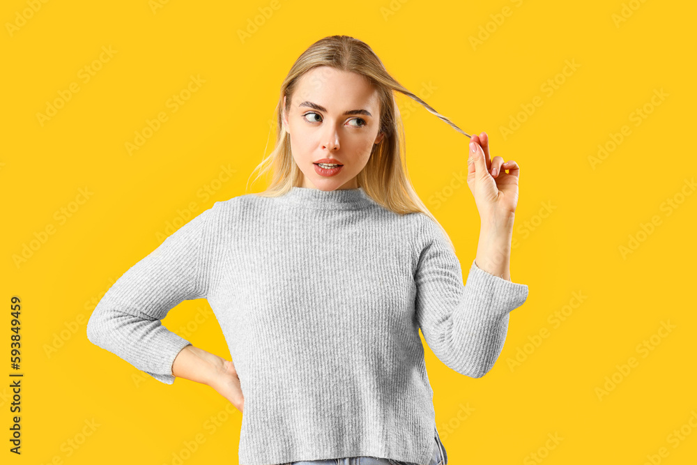 Dreaming young woman on yellow background