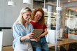 © NDABCREATIVITY - Portrait of happy young business women, designers smiling while working together in office