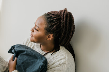 Sticker - Indoor portrait of beautiful brunette young african american woman smiling cheerfully while feeling happy and carefree on her first day off or holidays